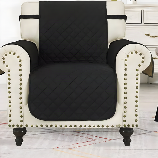 Black quilted armchair protector fitted over a cream studded armchair