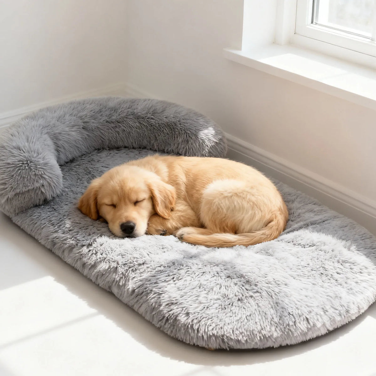 Puppy sleeping on the light grey plush crate bed with bolster
