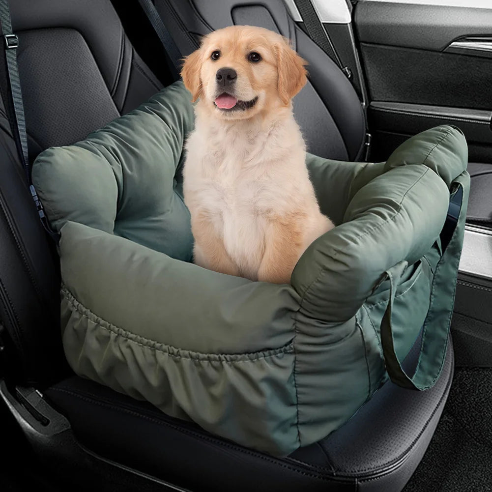 Golden retriever puppy in the olive green booster car seat bed on a car seat