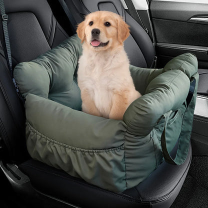 Golden retriever puppy in the olive green booster car seat bed on a car seat