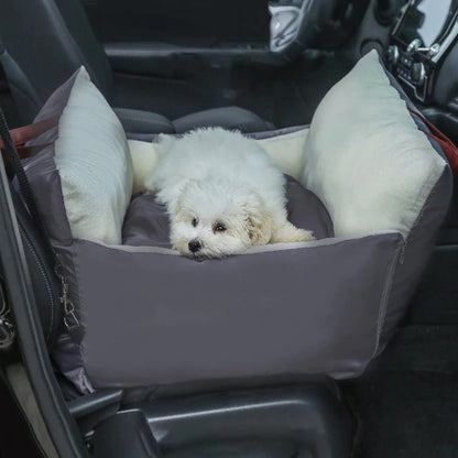 White dog lying in the grey and cream travel car seat bed on a car back seat