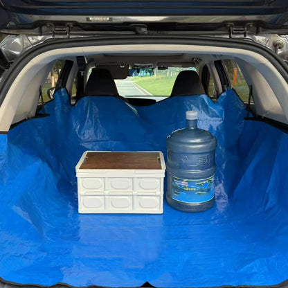 Blue side of the reversible boot liner covering a car boot floor and seats with luggage on top