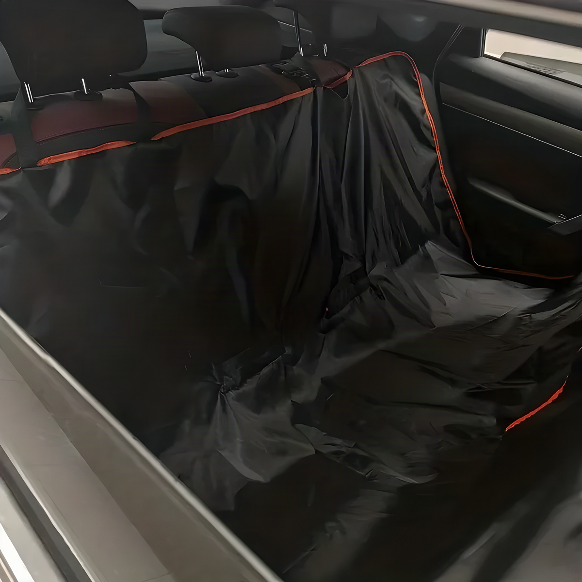 Black Oxford dog car hammock fitted in a car, side view showing the flaps