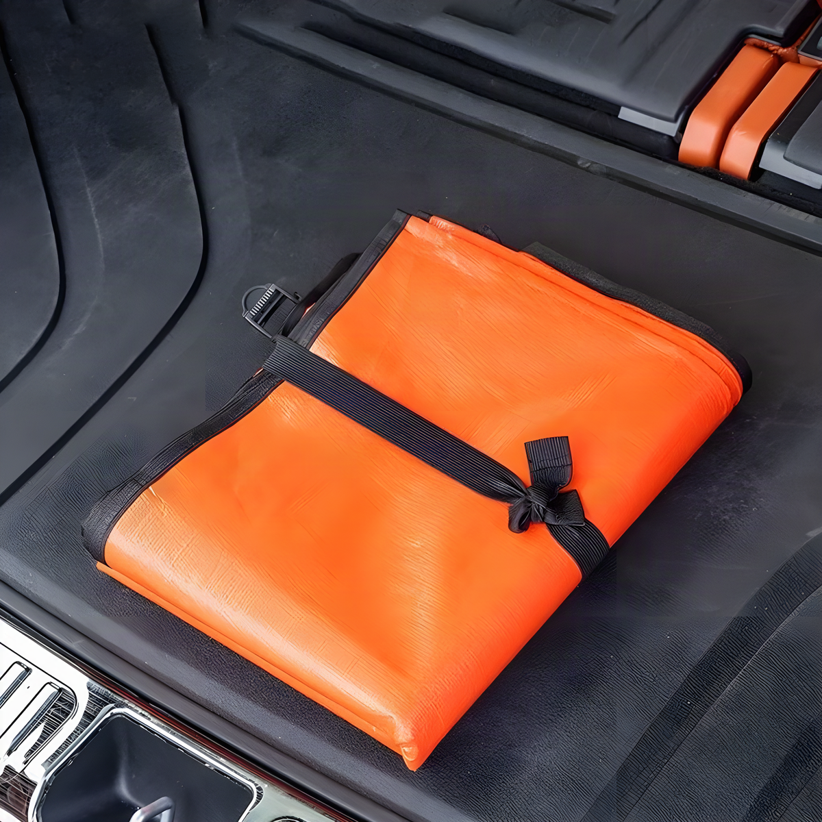 Reversible boot liner folded and strapped in a car boot